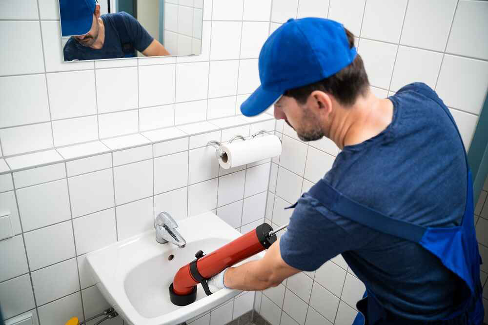 plumber cleaning drain